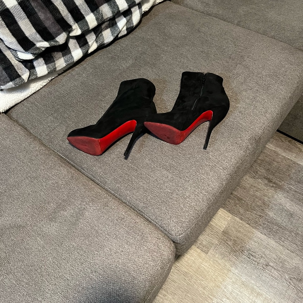 Christian Louboutin black booties red bottoms.